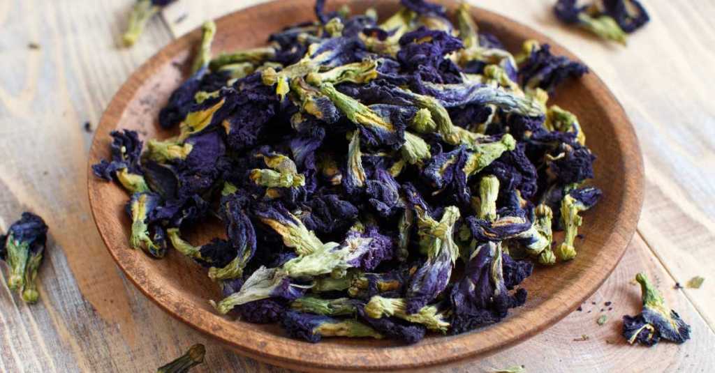 A bowl of dried butterfly pea flowers, ready for tea or use as a natural dye.