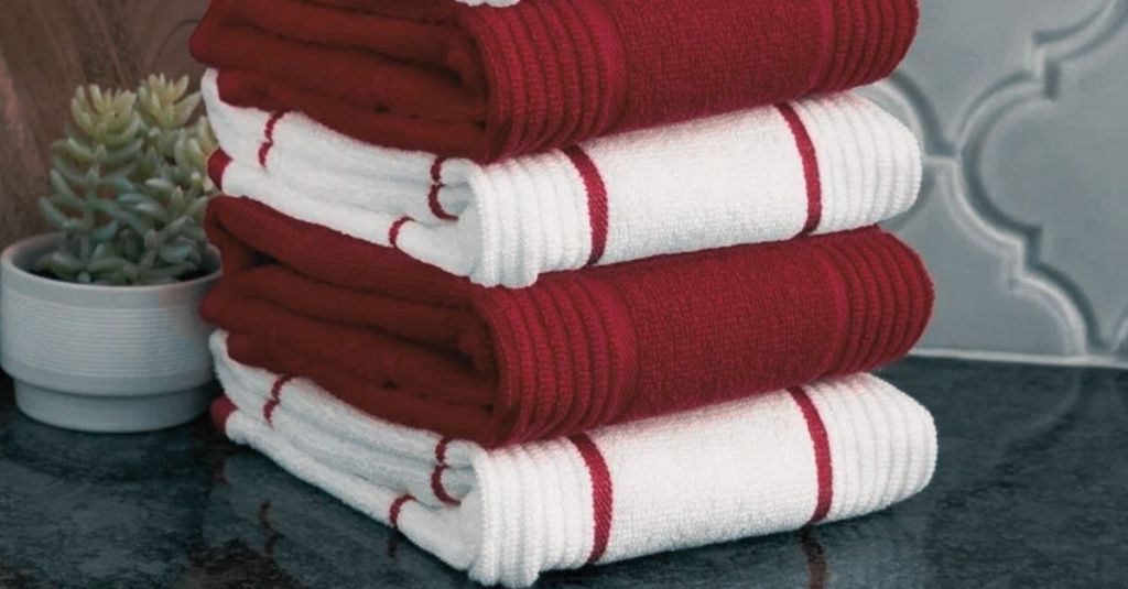 Stack of red and white hand towels with striped patterns