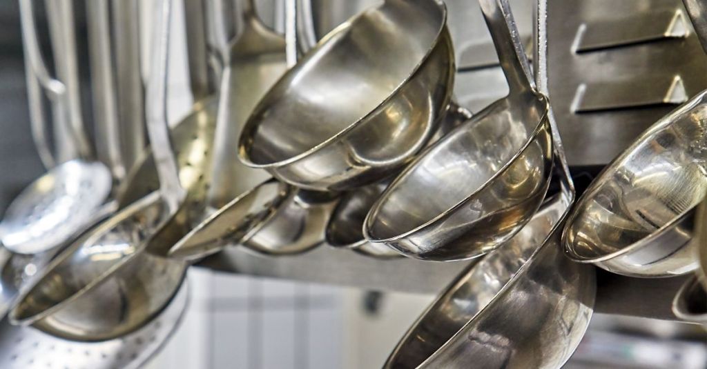 Hanging stainless steel ladles, perfect for serving soups, stews, and sauces in the kitchen.