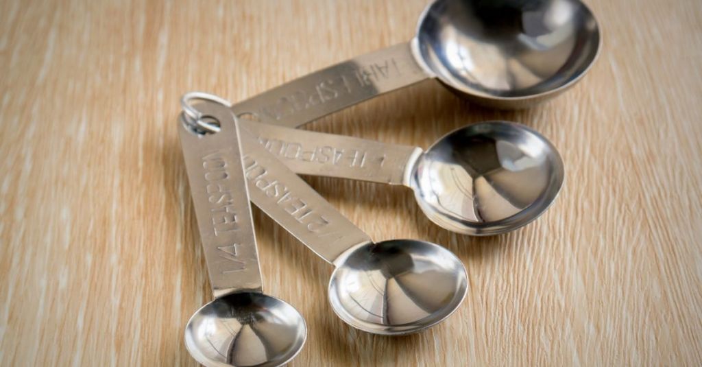 Stainless steel measuring spoons set for exact small ingredient measurements in recipes.