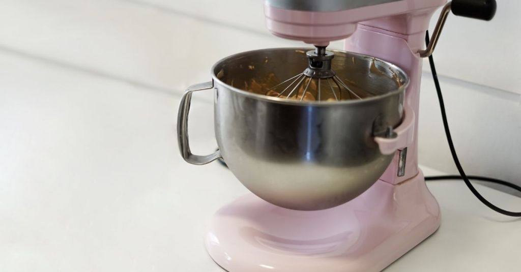 Stand mixer with a stainless steel bowl, essential for baking and dough preparation.