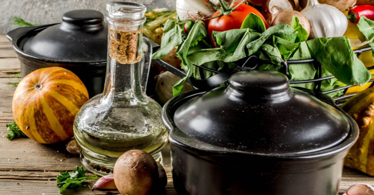Fresh vegetables and cast iron pots are essential for nutritious cooking. An arrangement of fresh vegetables and cast iron pots, emphasizing the connection between cooking methods and healthy plant-based meals.