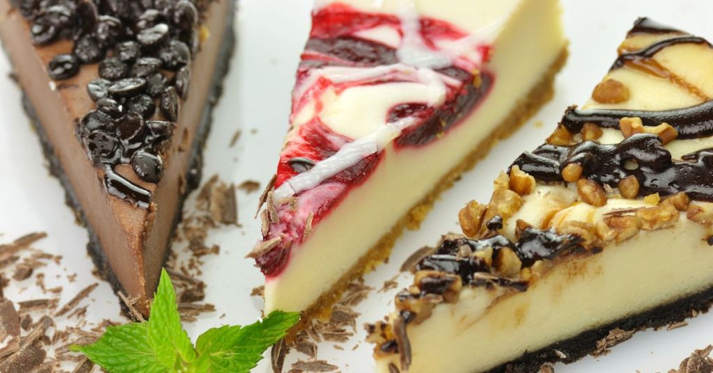 assorted dessert slices Three dessert slices with toppings: chocolate chips, raspberry swirl, and caramel with nuts, arranged on a white plate.