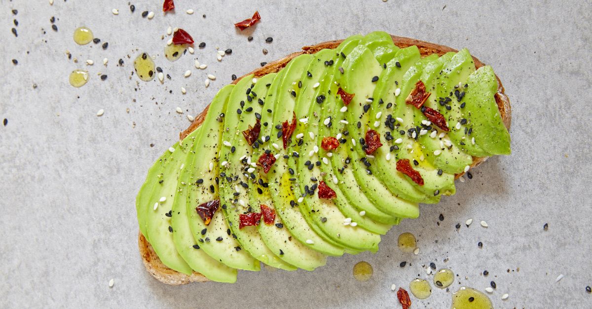 Avocado toast topped with cucumber ribbons and chili flakes, a satisfying savory breakfast. Avocado toast topped with light spices, a healthy choice for an energy-boosting breakfast.