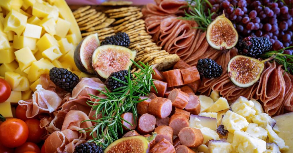 charcuterie board with figs, blackberries, meats, and cheeses