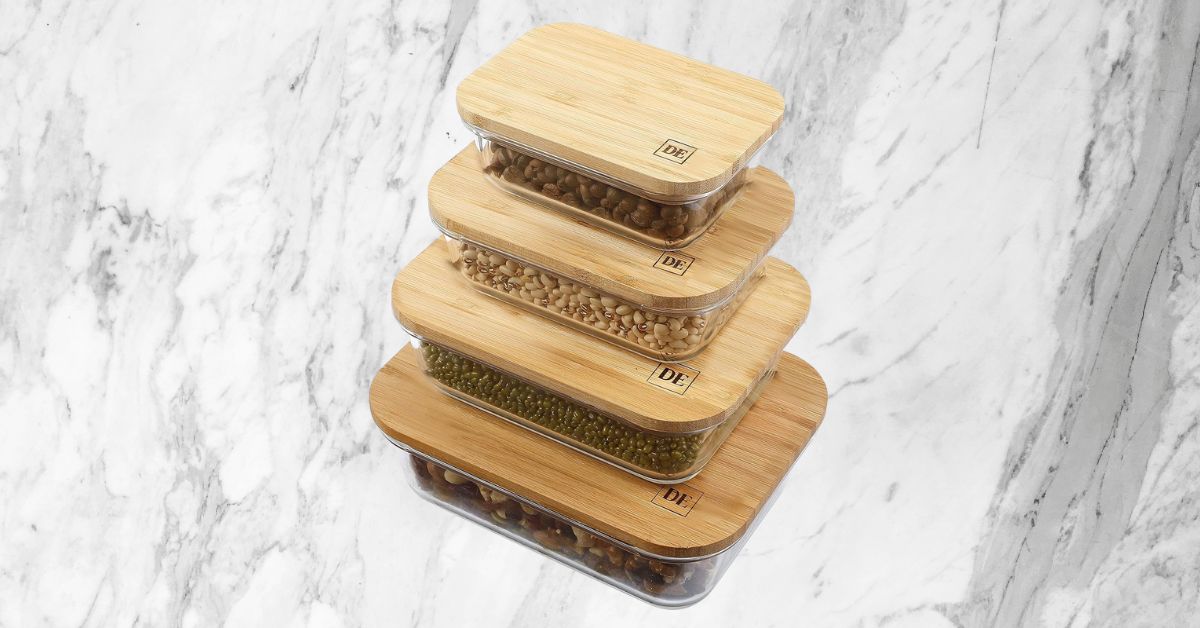 Sustainable glass food storage containers with bamboo lids, perfect as unique kitchen gifts for eco-conscious individuals. Set of stackable glass food storage containers with natural bamboo lids, perfect for eco-friendly kitchen organization.