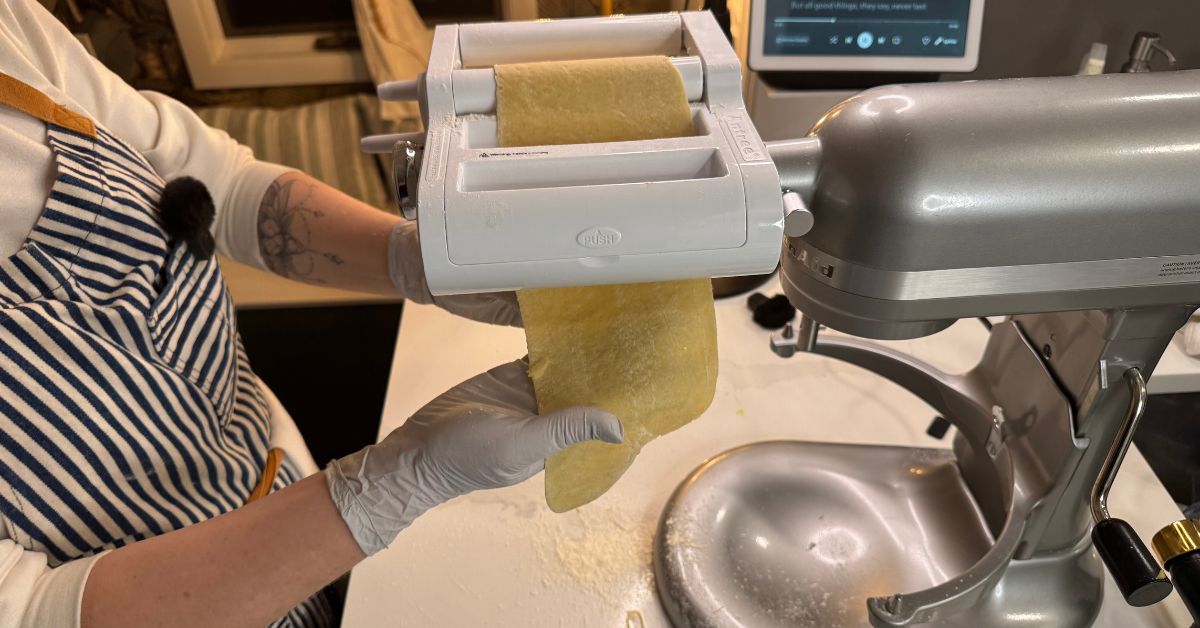 Handmade sheet of dough rolled out evenly on a wooden surface.