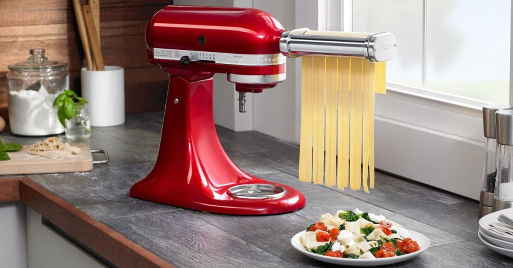 KitchenAid stand mixer with pasta roller attachment, rolling fresh dough into even sheets for homemade pasta.