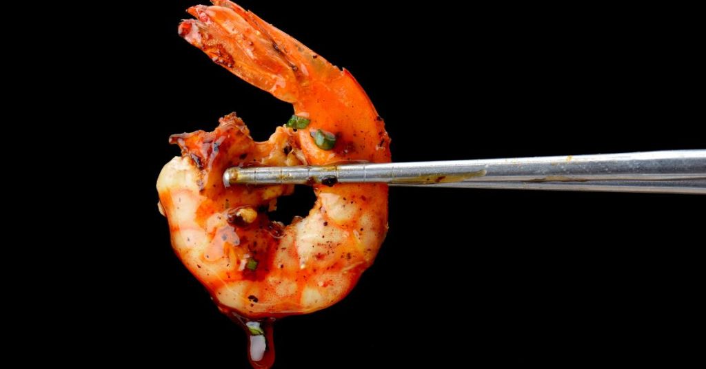 A single glazed shrimp seasoned with smoky spices, highlighting bold flavors in every bite.